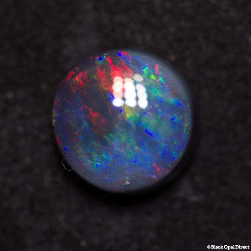 0.85 ct black opal 6mm round x3mm thick - Image 4