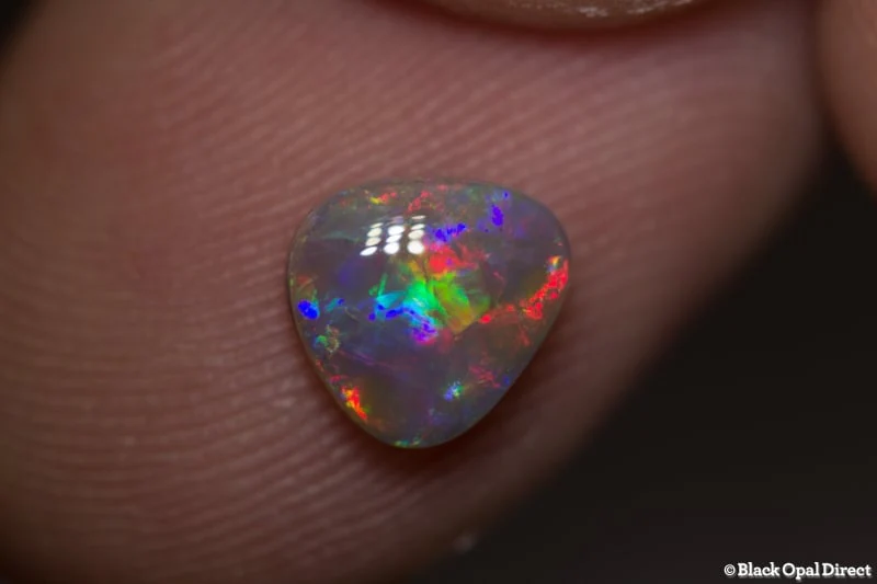 0.90 ct baroque semi black opal 7x7x3mm - Image 2