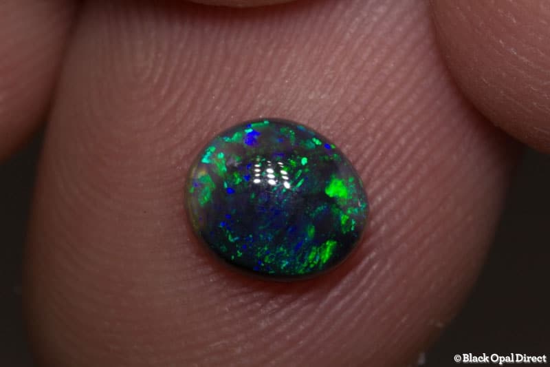 0.91 ct black opal 7x6x3mm - Image 2