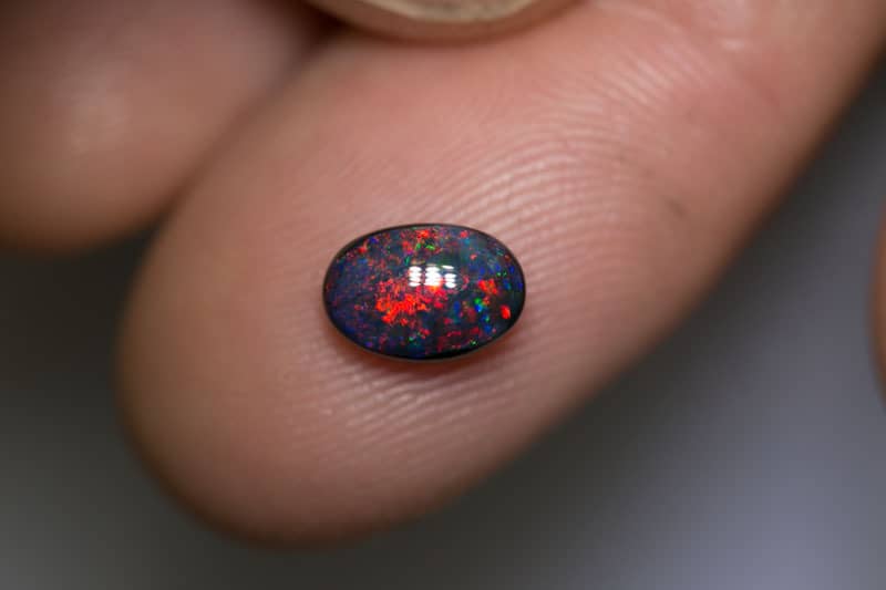 1.13 pigeon blood red black opal 8x5.5x3.5mm - Image 2