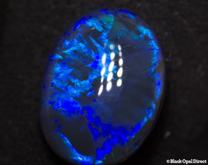 5.85 ct blue opal with chinese writing 14x10.5x6mm - Image 3